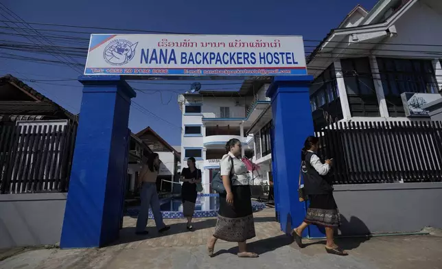 Health officials come out of Nana Backpackers hostel after checking documents in Vang Vieng, Laos, Friday, Nov. 22, 2024. (AP Photo/Anupam Nath)