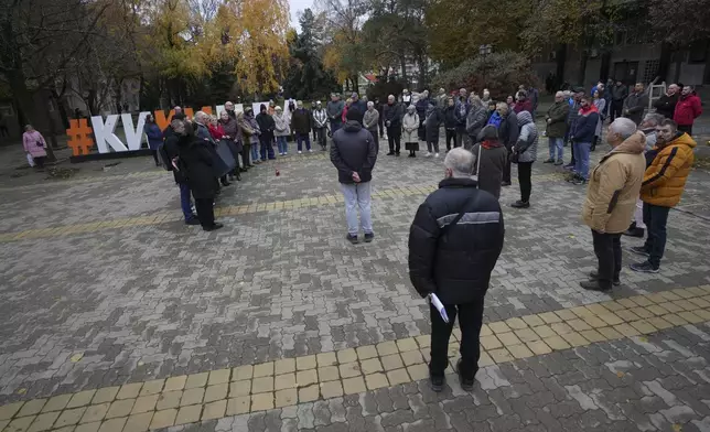 People stand in silence to commemorate the 15 victims of a railway roof collapse one month ago and demand accountability for the tragedy in Kikinda, Serbia, Friday, Nov. 29, 2024. (AP Photo/Darko Vojinovic)