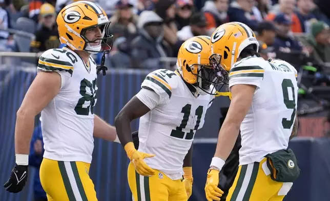 Green Bay Packers' Jayden Reed celebrates his touchdown catch with John FitzPatrick and Christian Watson during the first half of an NFL football game against the Chicago Bears Sunday, Nov. 17, 2024, in Chicago. (AP Photo/Charles Rex Arbogast)