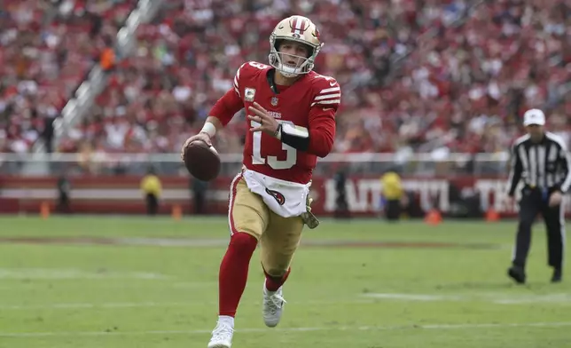 San Francisco 49ers quarterback Brock Purdy (13) runs toward the end zone to score against the Seattle Seahawks during the first half of an NFL football game in Santa Clara, Calif., Sunday, Nov. 17, 2024. (AP Photo/Jed Jacobsohn)