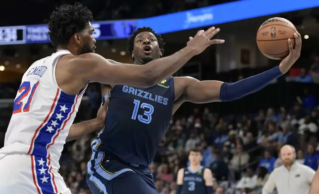 Memphis Grizzlies forward Jaren Jackson Jr. (13) shoots against Philadelphia 76ers center Joel Embiid (21) in the first half of an NBA basketball game Wednesday, Nov. 20, 2024, in Memphis, Tenn. (AP Photo/Brandon Dill)