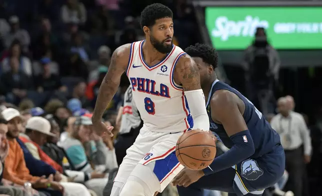 Philadelphia 76ers forward Paul George (8) handles the ball ahead of Memphis Grizzlies forward Jaren Jackson Jr. (13) in the first half of an NBA basketball game Wednesday, Nov. 20, 2024, in Memphis, Tenn. (AP Photo/Brandon Dill)