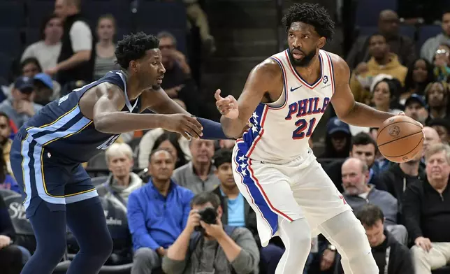 Philadelphia 76ers center Joel Embiid (21) handles the ball against Memphis Grizzlies forward Jaren Jackson Jr. (13) in the first half of an NBA basketball game Wednesday, Nov. 20, 2024, in Memphis, Tenn. (AP Photo/Brandon Dill)