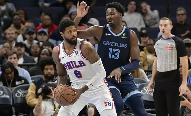 Philadelphia 76ers forward Paul George (8) handles the ball against Memphis Grizzlies forward Jaren Jackson Jr. (13) in the first half of an NBA basketball game Wednesday, Nov. 20, 2024, in Memphis, Tenn. (AP Photo/Brandon Dill)