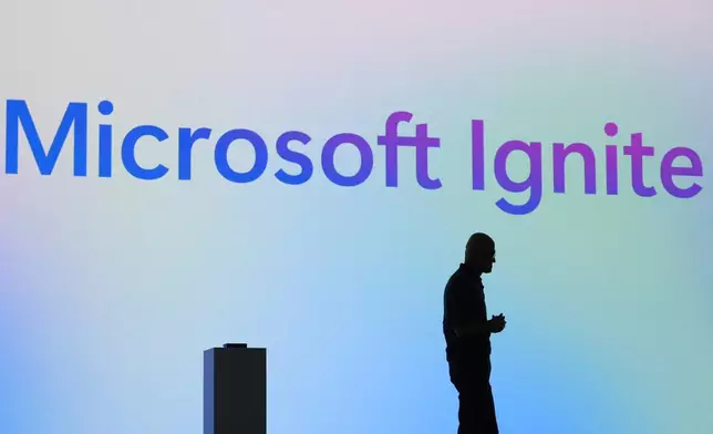 Microsoft CEO Satya Nadella stands in silhouette during the Microsoft Ignite conference Tuesday, Nov. 19, 2024, in Chicago. (AP Photo/Charles Rex Arbogast)