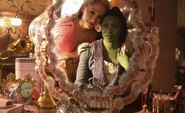 This image released by Universal Pictures shows Ariana Grande, as Glinda, left, and Cynthia Erivo, as Elphaba, in a scene from the film "Wicked." (Giles Keyte/Universal Pictures via AP)