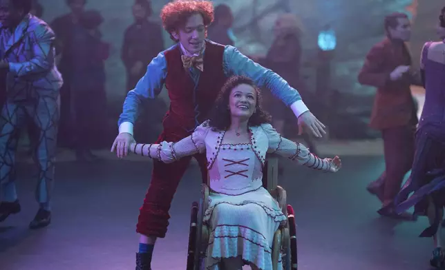 This image released by Universal Pictures shows Ethan Slater, left, and Marissa Bode in a scene from the film "Wicked." (Giles Keyte/Universal Pictures via AP)