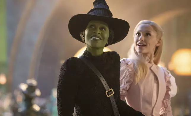 This image released by Universal Pictures shows Cynthia Erivo, left, and Ariana Grande in a scene from the film "Wicked." (Giles Keyte/Universal Pictures via AP)