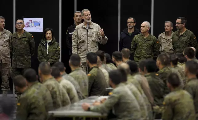 Spain's King Felipe VI, speaks to the troops as he visits a military base on the outskirts of Valencia after floods left hundreds dead or missing in the Valencia region in Spain, Tuesday, Nov. 12, 2024. (AP Photo/Alberto Saiz)