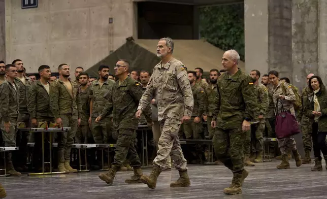 Spain's King Felipe VI, visits a military base on the outskirts of Valencia after floods left hundreds dead or missing in the Valencia region in Spain, Tuesday, Nov. 12, 2024. (AP Photo/Alberto Saiz)