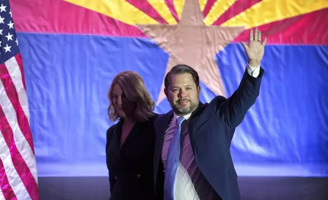 Arizona Democratic Senate candidate Rep. Ruben Gallego, D-Ariz., waves to the crowd as he leaves the stage his wife Sydney Gallego after speaking during a watch party on election night Tuesday, Nov. 5, 2024, in Phoenix. (AP Photo/Ross D. Franklin)