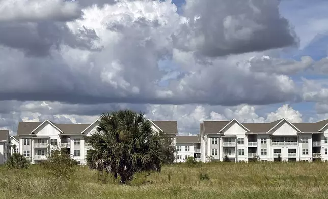 The newly-constructed The Brightly Apartments rises from what was formally a citrus grove nearby Haines City, Florida Saturday, Oct. 5, 2024. (AP Photo/Mike Schneider)