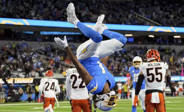 Los Angeles Chargers wide receiver Quentin Johnston (1) does a back flip in the end zone after his touchdown catch during the first half of an NFL football game against the Cincinnati Bengals, Sunday, Nov. 17, 2024, in Inglewood, Calif. (AP Photo/Gregory Bull)