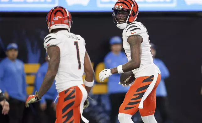 Cincinnati Bengals wide receiver Tee Higgins, right, celebrates his touchdown catch with wide receiver Ja'Marr Chase (1) during the second half of an NFL football game against the Los Angeles Chargers, Sunday, Nov. 17, 2024, in Inglewood, Calif. (AP Photo/Eric Thayer)