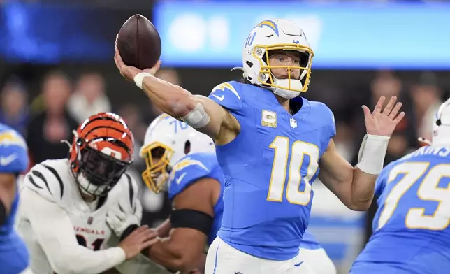 Los Angeles Chargers quarterback Justin Herbert (10) throws a pass during the first half of an NFL football game against the Cincinnati Bengals, Sunday, Nov. 17, 2024, in Inglewood, Calif. (AP Photo/Gregory Bull)