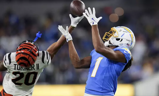 Cincinnati Bengals cornerback DJ Turner II (20) breaks up a pass intended for Los Angeles Chargers wide receiver Quentin Johnston (1) during the second half of an NFL football game Sunday, Nov. 17, 2024, in Inglewood, Calif. (AP Photo/Gregory Bull)