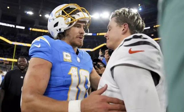 Los Angeles Chargers quarterback Justin Herbert (10) talks to Cincinnati Bengals quarterback Joe Burrow after an NFL football game Sunday, Nov. 17, 2024, in Inglewood, Calif. (AP Photo/Eric Thayer)