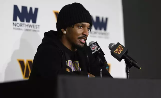 Washington Commanders quarterback Jayden Daniels (5) answers questions during a press conference after an NFL football game against the Dallas Cowboys, Sunday, Nov. 24, 2024, in Landover, Md. The Cowboys won 34-26. (AP Photo/Nick Wass)