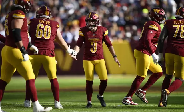 Washington Commanders place kicker Austin Seibert (3) celebrates after kicking a 41-yard field goal during the first half of an NFL football game against the Dallas Cowboys, Sunday, Nov. 24, 2024, in Landover, Md. (AP Photo/Nick Wass)