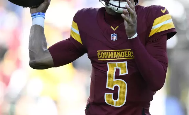 Washington Commanders quarterback Jayden Daniels (5) passes during the first half of an NFL football game against the Dallas Cowboys, Sunday, Nov. 24, 2024, in Landover, Md. (AP Photo/Nick Wass)