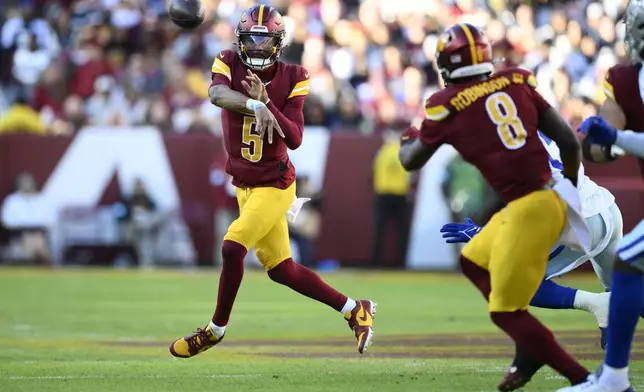 Washington Commanders quarterback Jayden Daniels (5) passes during the first half of an NFL football game against the Dallas Cowboys, Sunday, Nov. 24, 2024, in Landover, Md. (AP Photo/Nick Wass)