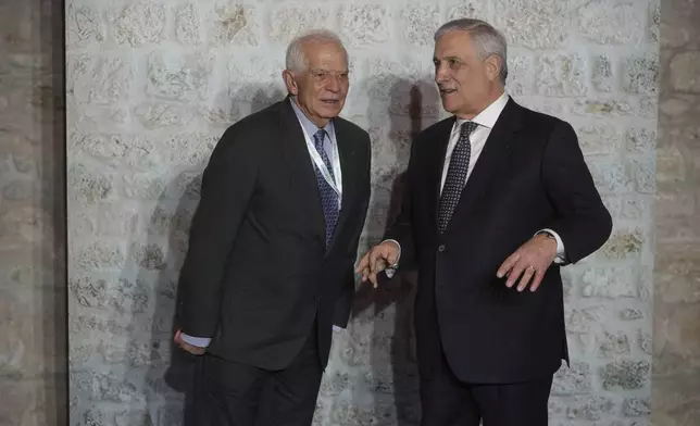 Italian Foreign Minister Antonio Tajani, right, and and European Union foreign policy chief Josep Borrell prepare for a family photo at the G7 of foreign Ministers in Anagni, some 70 kilometers south-east of Rome, Monday, Nov. 25, 2024. (AP Photo/Alessandra Tarantino)