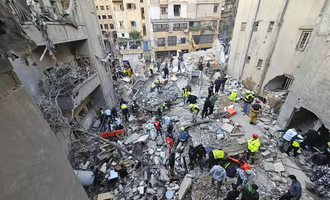 Rescuers search for victims at the site of an Israeli airstrike that targeted a building in Beirut, Lebanon, Tuesday, Nov. 26, 2024. (AP Photo/Hassan Ammar)