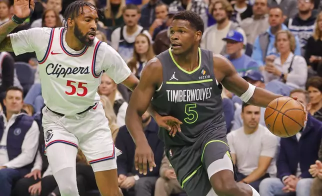 Minnesota Timberwolves guard Anthony Edwards (5) works around Los Angeles Clippers forward Derrick Jones Jr. (55) in the first quarter of an Emirates NBA Cup basketball game Friday, Nov. 29, 2024, in Minneapolis. (AP Photo/Bruce Kluckhohn)