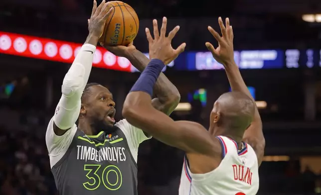 Minnesota Timberwolves forward Julius Randle (30) shoots against Los Angeles Clippers guard Kris Dunn (8) in the first quarter of an NBA basketball game Friday, Nov. 29, 2024, in Minneapolis. (AP Photo/Bruce Kluckhohn)