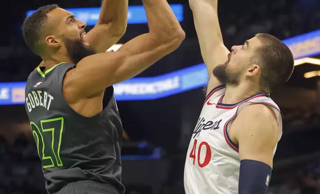 Minnesota Timberwolves center Rudy Gobert (27) shoots against Los Angeles Clippers center Ivica Zubac (40) in the first quarter of an Emirates NBA Cup basketball game Friday, Nov. 29, 2024, in Minneapolis. (AP Photo/Bruce Kluckhohn)