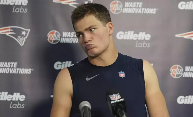 New England Patriots quarterback Drake Maye grimaces during a news conference following an NFL football game against the Miami Dolphins, Sunday, Nov. 24, 2024, in Miami Gardens, Fla. (AP Photo/Lynne Sladky)