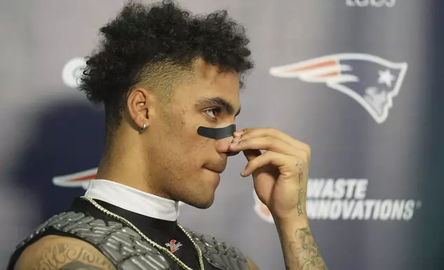 New England Patriots cornerback Christian Gonzalez (0) listens to a question during a news conference following an NFL football game against the Miami Dolphins, Sunday, Nov. 24, 2024, in Miami Gardens, Fla. (AP Photo/Lynne Sladky)