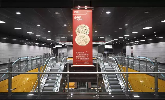 A banner referring to the ancient antiquities on display at the newly built Agias Sofias metro station ahead of its Nov. 30 official opening, in Thessaloniki, northern Greece, Friday, Nov. 22, 2024 – part of the city's long-delayed subway system showcasing archaeological finds from decades of construction. (AP Photo/Giannis Papanikos)