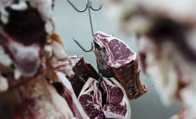 Beef hangs in the meat locker of J.T. Jobbagy Inc. in the Meatpacking District of Manhattan, Tuesday, Nov. 19, 2024, in New York. (AP Photo/Julia Demaree Nikhinson)