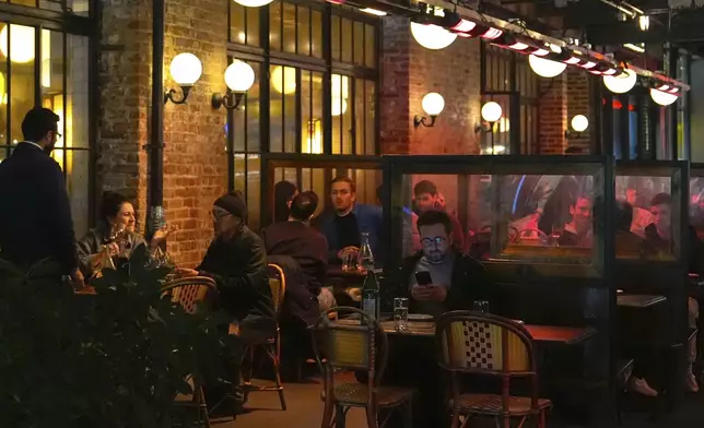 Diners eat at a restaurant in the Meatpacking District of Manhattan, Friday, Nov. 22, 2024, in New York. (AP Photo/Julia Demaree Nikhinson)