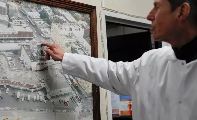 John Jobbagy explains a photo of the Meatpacking District of Manhattan during an interview with The Associated Press at J.T. Jobbagy Inc. in the Meatpacking District of Manhattan, Tuesday, Nov. 19, 2024, in New York. (AP Photo/Julia Demaree Nikhinson)