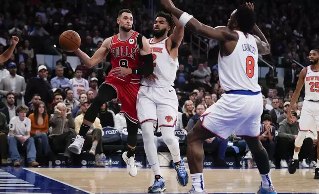 Chicago Bulls' Zach LaVine, left, is fouled by New York Knicks' Karl-Anthony Towns, second from left, as he attempts to pass during the second half of an NBA basketball game, Wednesday, Nov. 13, 2024, in New York. The Bulls defeated the Knicks 124-123. (AP Photo/Seth Wenig)