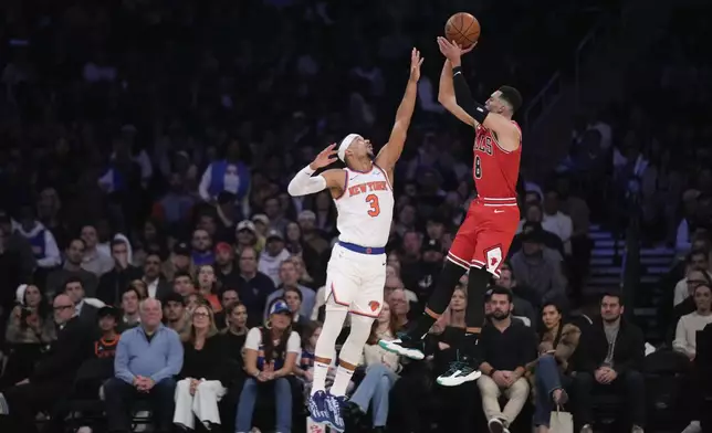 Chicago Bulls' Zach LaVine, right, puts up a shot over New York Knicks' Josh Hart during the first half of an NBA basketball game, Wednesday, Nov. 13, 2024, in New York. (AP Photo/Seth Wenig)