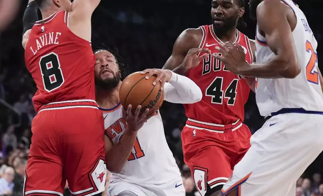 New York Knicks' Jalen Brunson, second from left, drives to the basket past Chicago Bulls' Zach LaVine (8), left, and Patrick Williams (44) during the first half of an NBA basketball game, Wednesday, Nov. 13, 2024, in New York. (AP Photo/Seth Wenig)