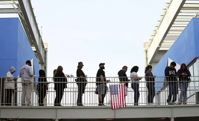 Voters wait in a long line at a polling place at the Michelle and Barack Obama Sports Complex on Election Day, Tuesday, Nov. 5, 2024, in Los Angeles. (AP Photo/Chris Pizzello)