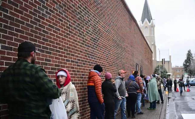 Voters line up outside the Gallatin County Courthouse on Election Day in Bozeman, Mont., on Tuesday, Nov. 5, 2024. (AP Photo/Tommy Martino)