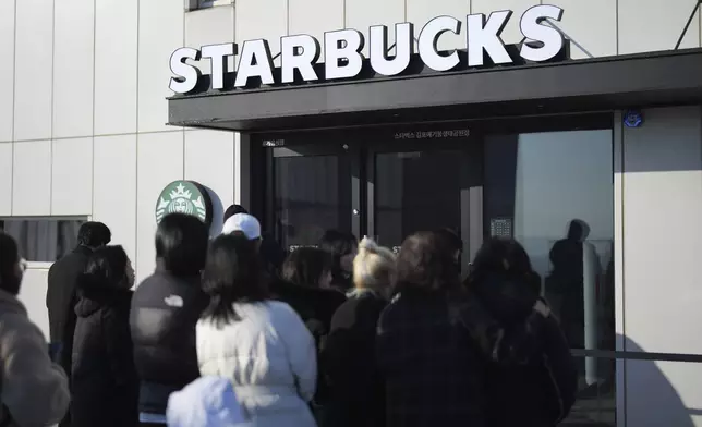 Visitors wait to enter at newly opened Starbucks store at the observatory of the Aegibong Peace Ecopark in Gimpo, South Korea, Friday, Nov. 29, 2024. (AP Photo/Lee Jin-man)