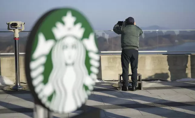 A visitor watched North Korean side at the observatory of the Aegibong Peace Ecopark in Gimpo, South Korea, Friday, Nov. 29, 2024. (AP Photo/Lee Jin-man)