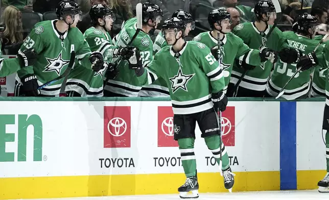 Dallas Stars center Wyatt Johnston (53) celebrates with the bench after scoring against the San Jose Sharks in the second period of an NHL hockey game in Dallas, Wednesday, Nov. 20, 2024. (AP Photo/Tony Gutierrez)