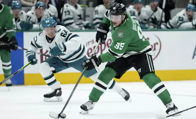 Dallas Stars center Matt Duchene (95) positions to shoot as San Jose Sharks' Mikael Granlund (64) moves in to defend in the first period of an NHL hockey game in Dallas, Wednesday, Nov. 20, 2024. (AP Photo/Tony Gutierrez)