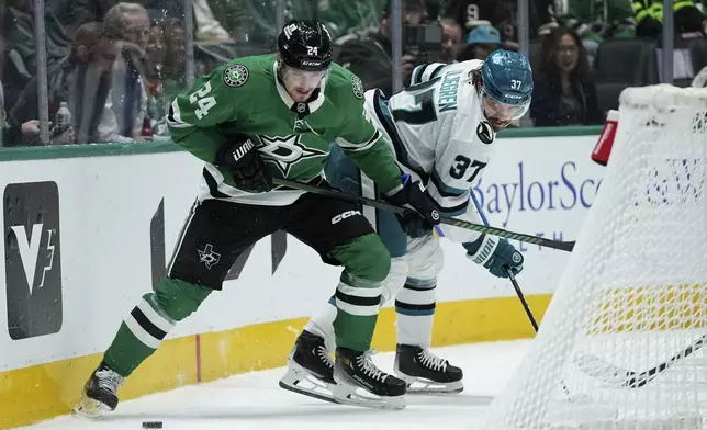 Dallas Stars center Roope Hintz (24) looks to make a pass as San Jose Sharks' Timothy Liljegren (37) defends in the first period of an NHL hockey game in Dallas, Wednesday, Nov. 20, 2024. (AP Photo/Tony Gutierrez)