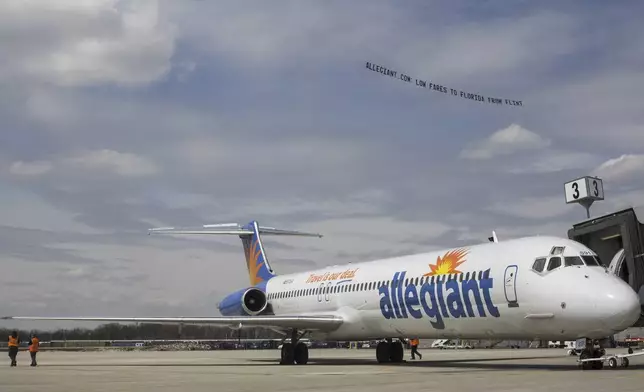 FILE - A small plane tows a banner over Flint Bishop Airport as part of ceremonies marking Allegiant Air joining Flint Bishop International Airport on April 13, 2016. (Conor Ralph/The Flint Journal- MLive.com via AP, File)