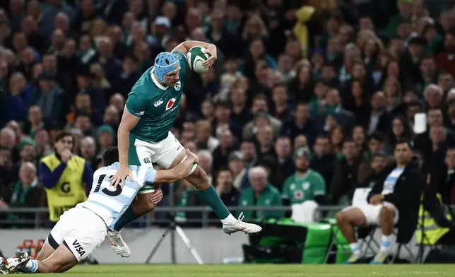 Ireland's Tadhg Beirne, right, is tackled by Argentina's Lucio Cinti during the Autumn Nations series rugby union match between Ireland and Argentina, at Aviva Stadium, Dublin, Ireland, Friday, Nov. 15, 2024. (AP Photo/Peter Morrison)