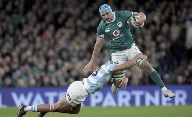 Ireland's Tadhg Beirne is tackled by Argentina's Lucio Cinti during the Autumn Nations series rugby union match between Ireland and Argentina, at Aviva Stadium, Dublin, Ireland, Friday, Nov. 15, 2024. (Brian Lawless//PA via AP)