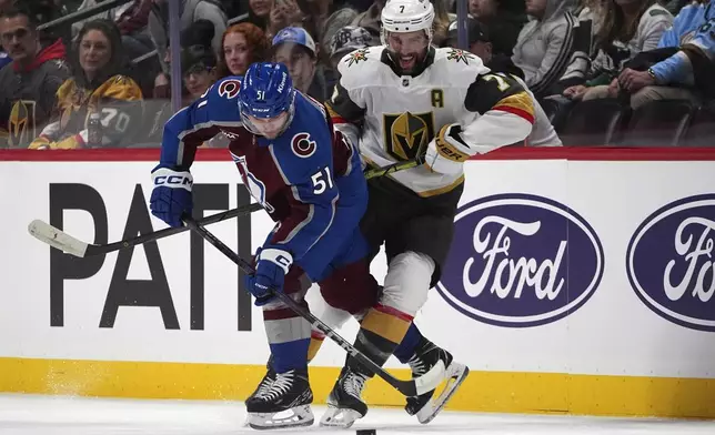 Colorado Avalanche right wing Nikolai Kovalenko, left, gets tangled up with Vegas Golden Knights defenseman Alex Pietrangelo in the first period of an NHL hockey game Wednesday, Nov. 27, 2024, in Denver. (AP Photo/David Zalubowski)